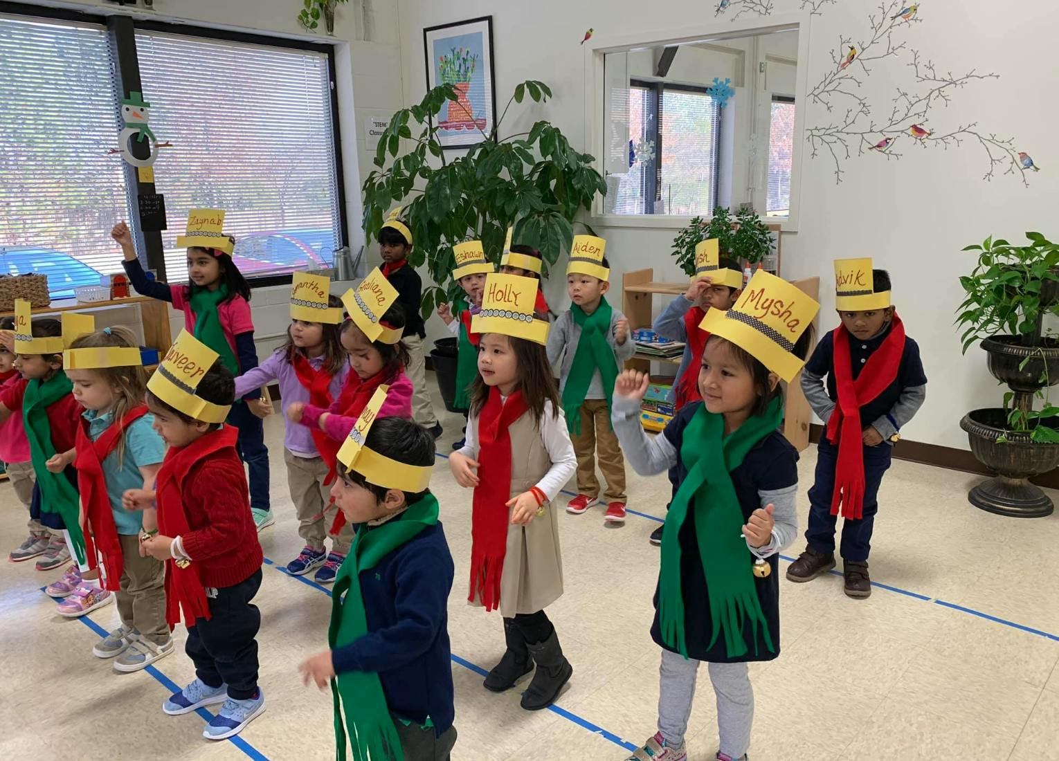 Group of children in yellow hats and red and green scarves