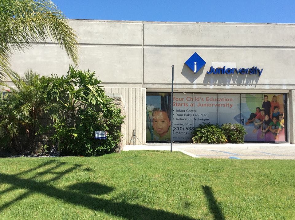 Building exterior with "J Interverity" sign and window displays