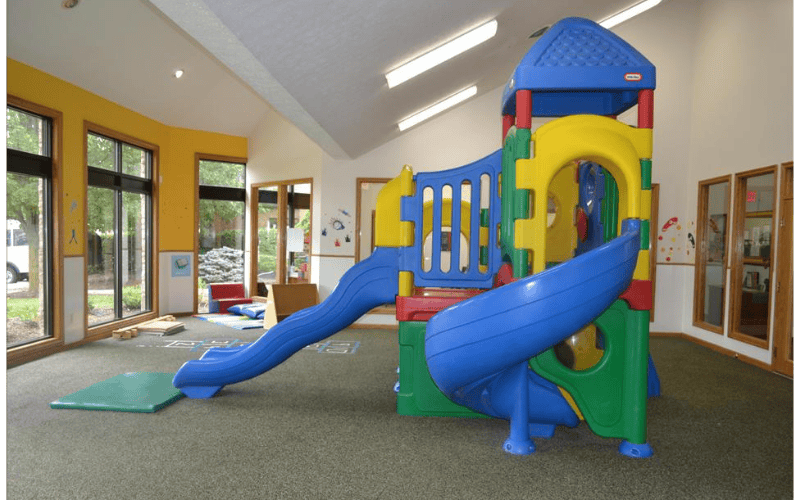indoor playground with a colorful slide and climbing structure
