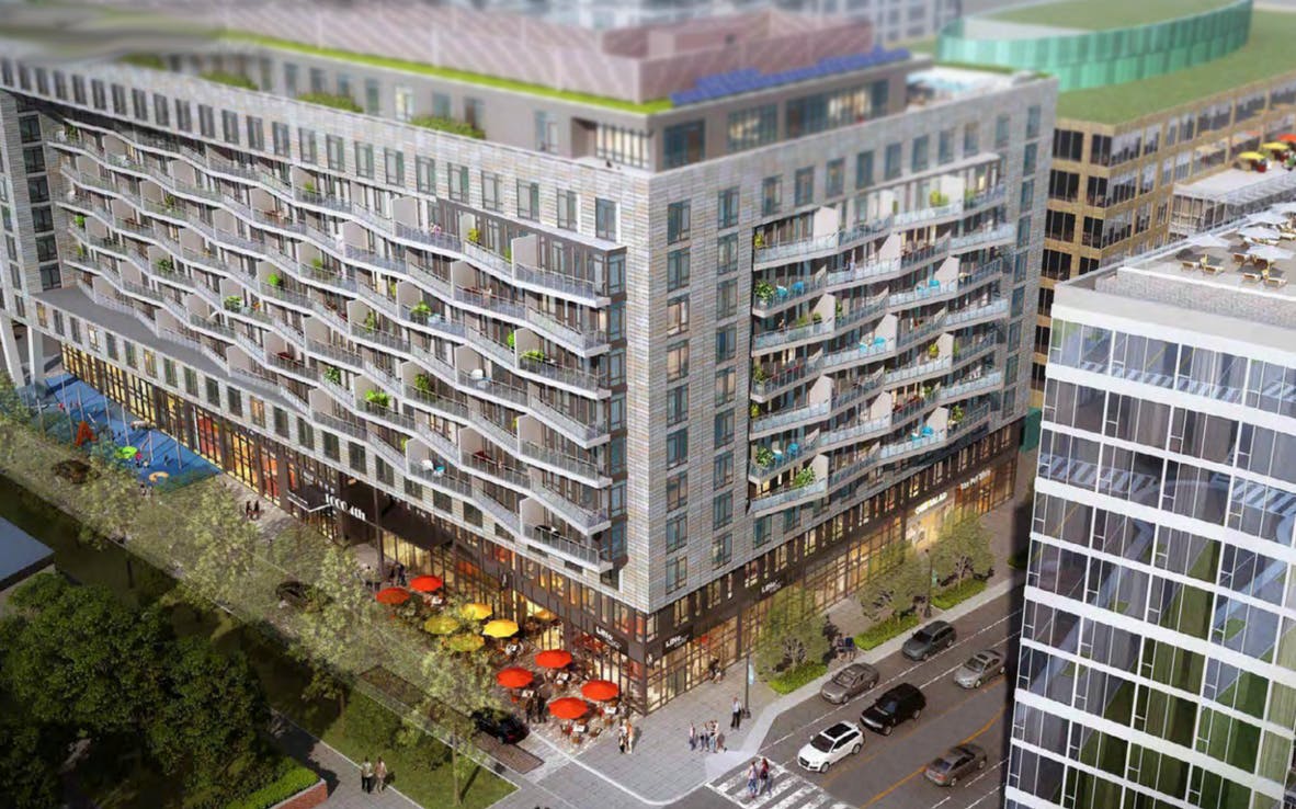 Aerial view of a large building with balconies and ground-floor businesses
