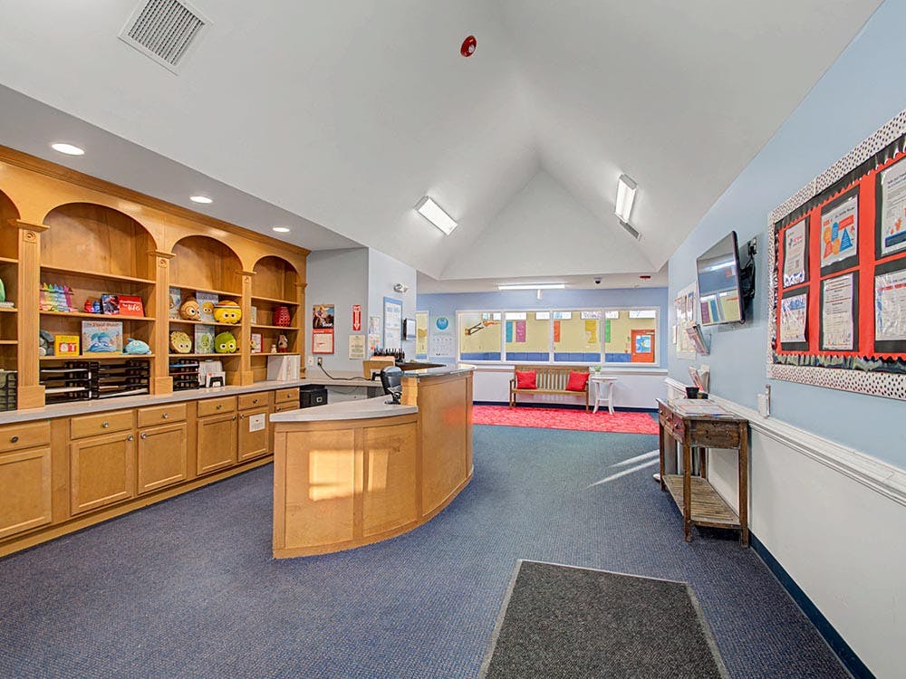 Reception desk with shelves and bulletin boards in a lobby