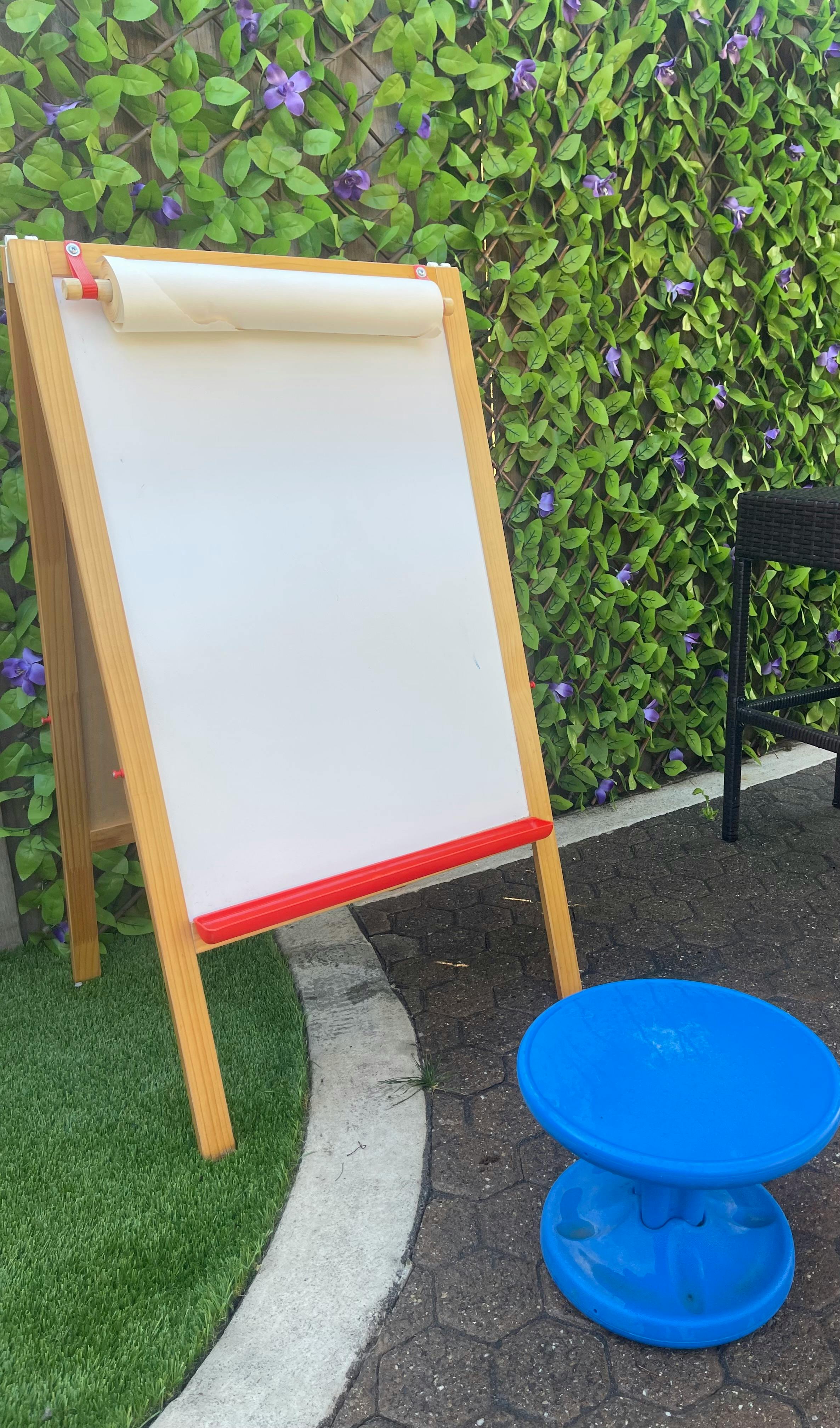 Easel with a roll of paper and a blue stool