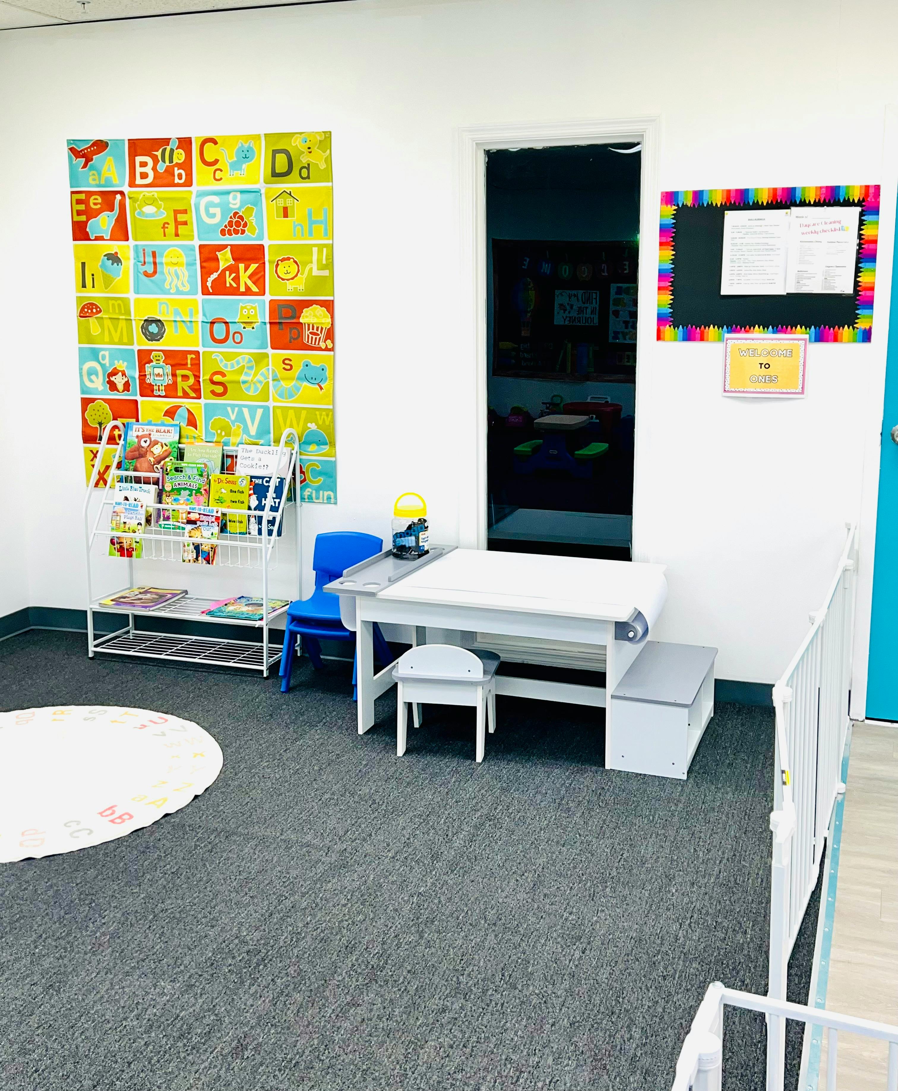 classroom with alphabet chart, book display, and small table with chairs