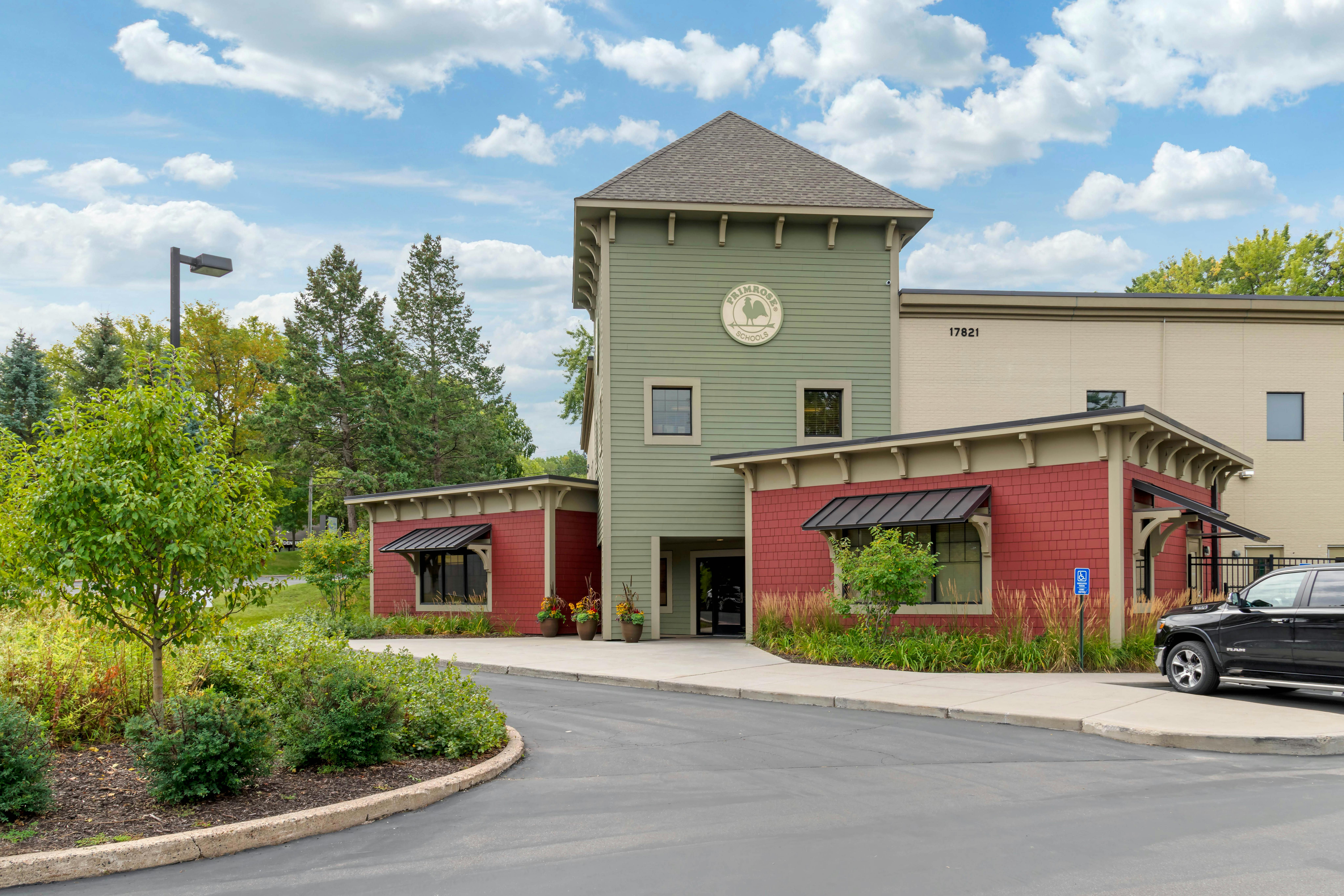 Primrose Schools building with red and green siding