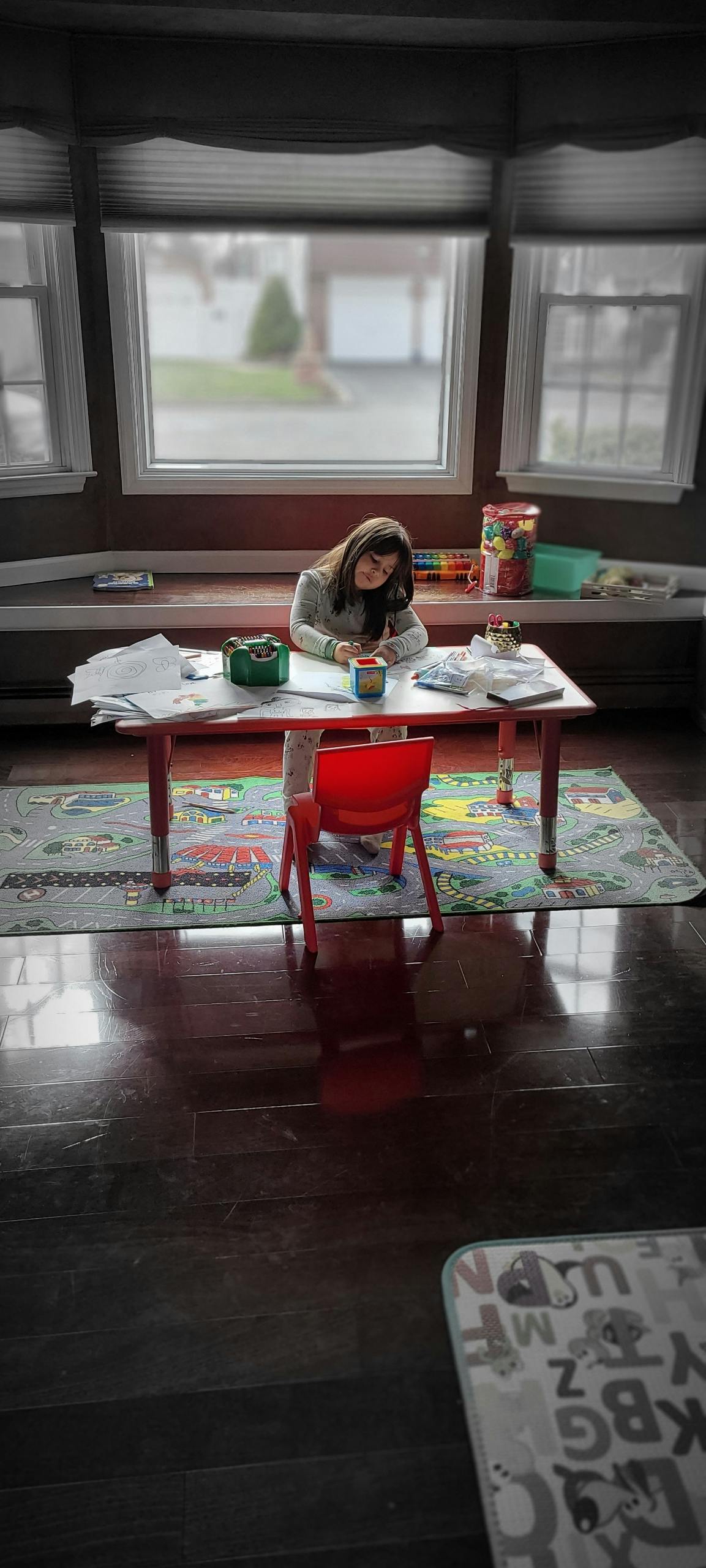 Child sitting at a table drawing