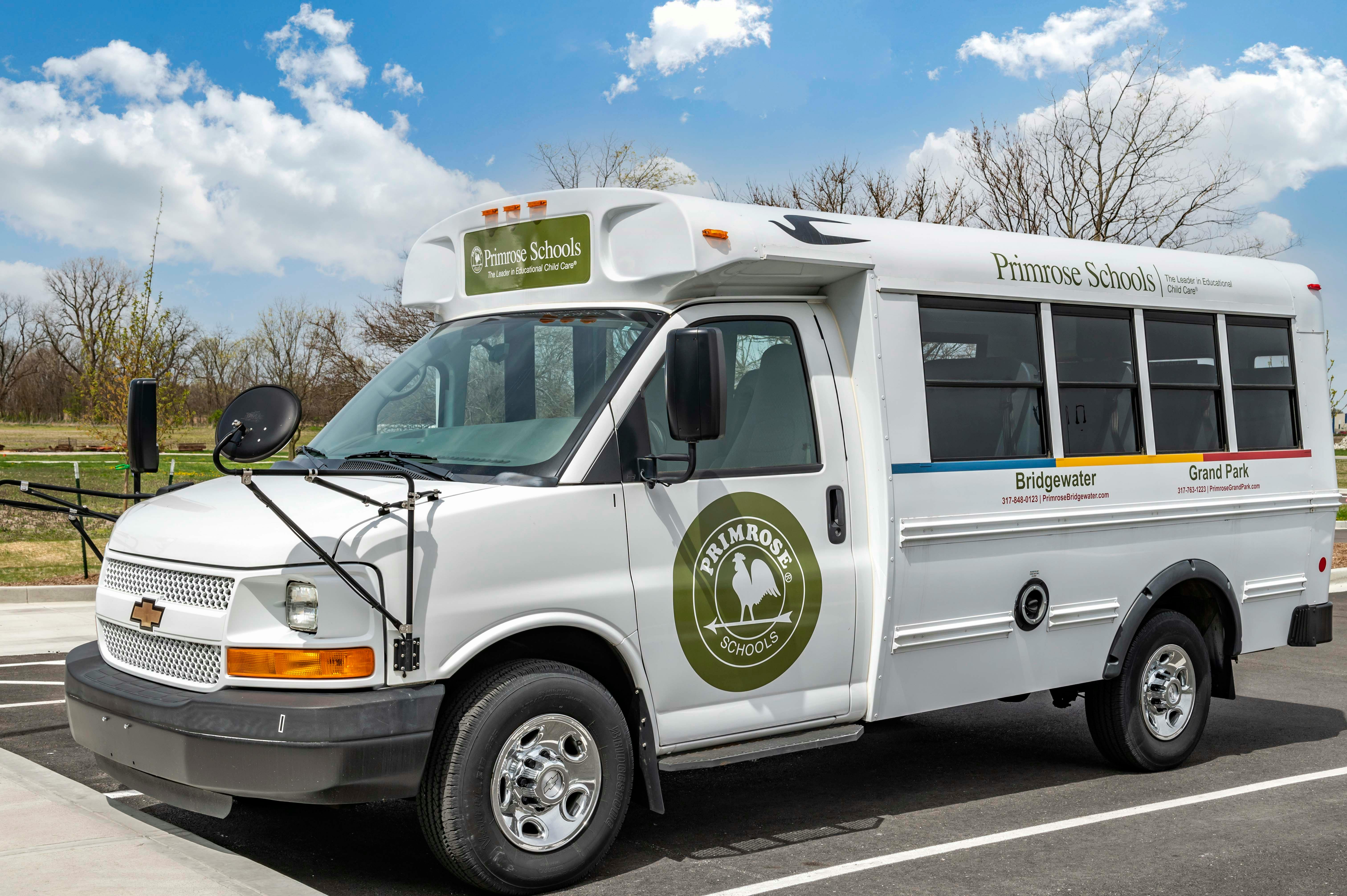 white Primrose Schools bus with 'The Leader in Educational Child Care' text