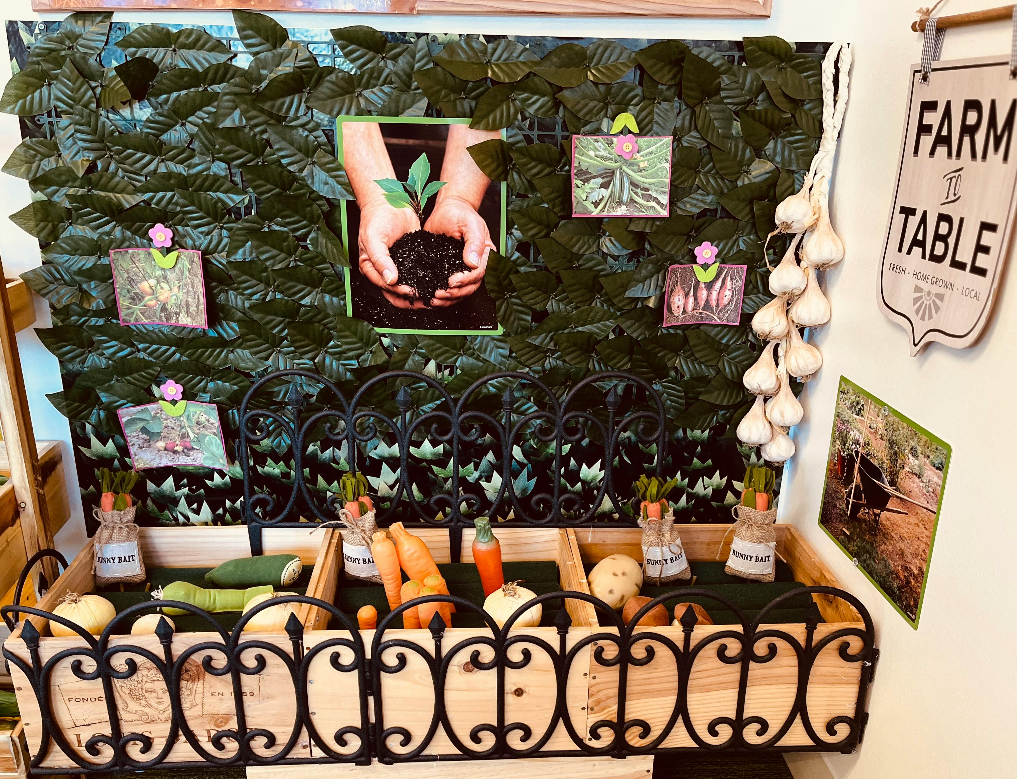 Produce display with carrots, zucchini, and garlic, with a "Farm to Table" sign