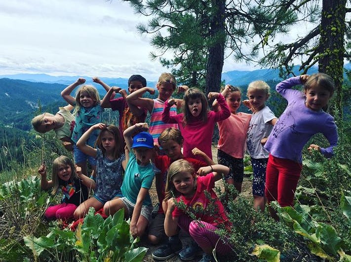 Group of children posing with flexed arms outdoors