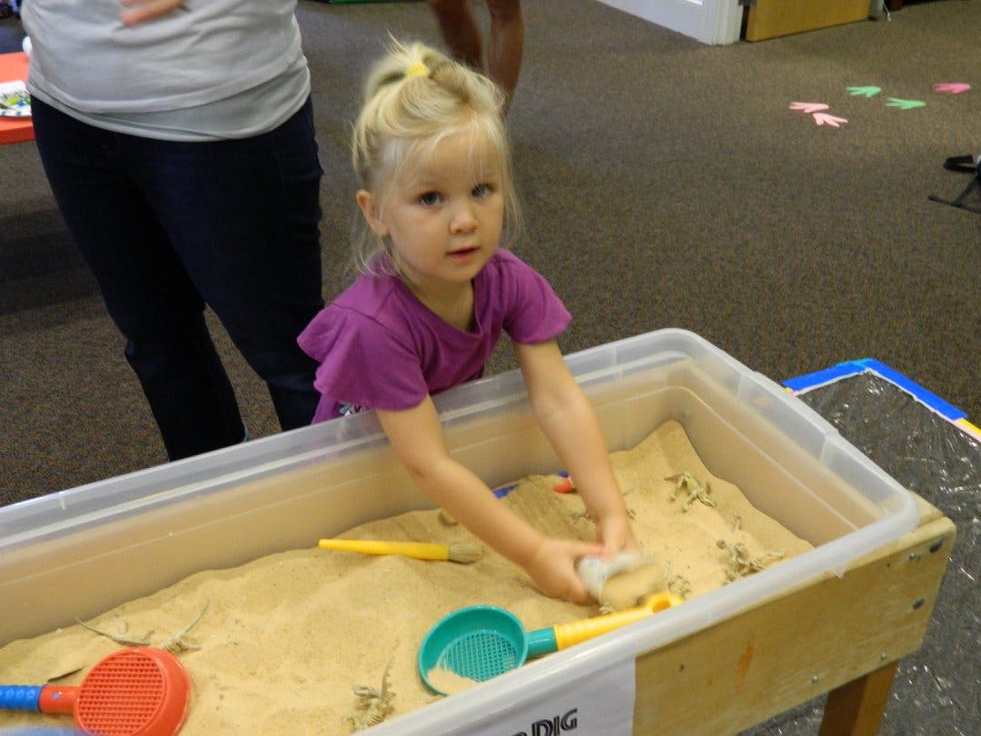 Child playing in a sand table
