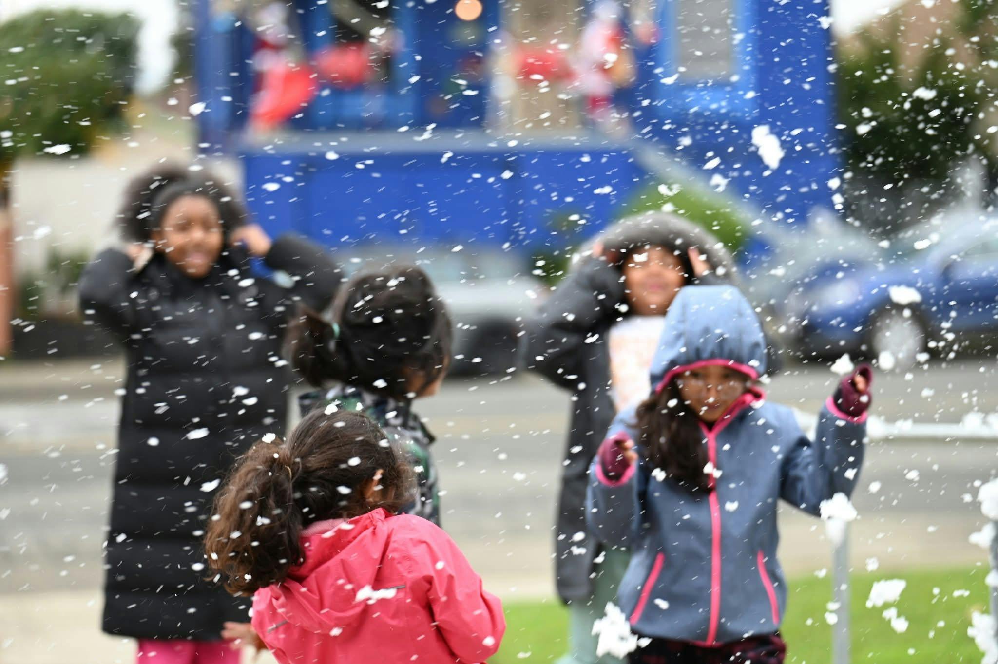 Children playing in falling snow