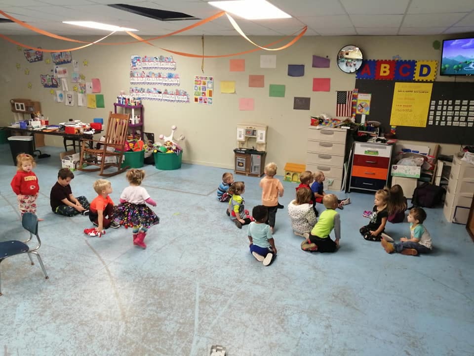 Children sitting on the floor in a classroom