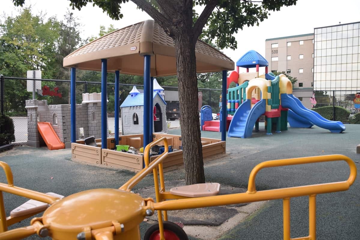 Playground with a sandbox, slides, and a yellow seesaw