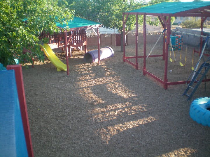 Outdoor playground with slide, tunnel, and swing set