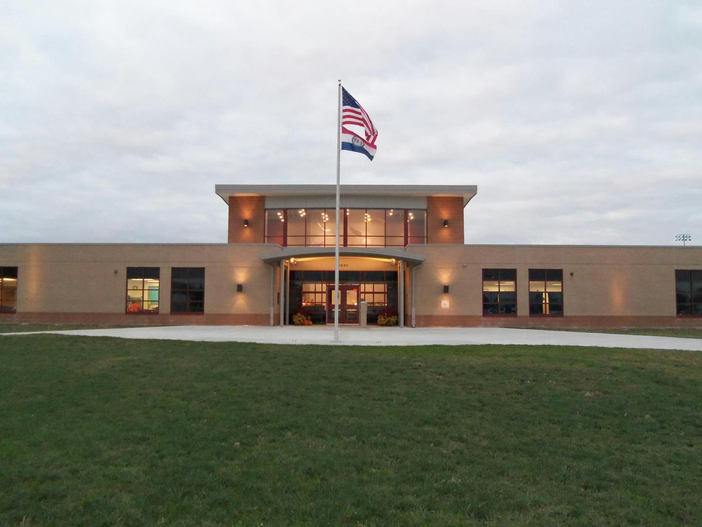 Building exterior with an American flag on a flagpole in front