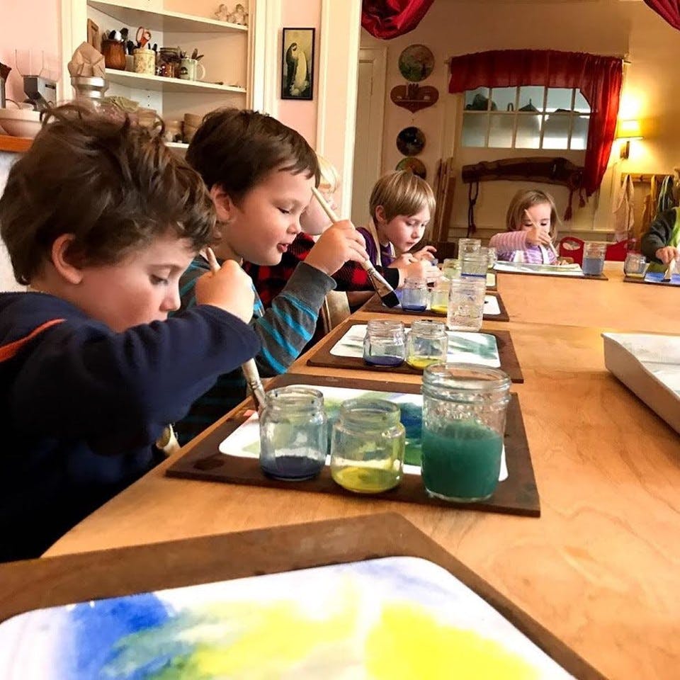 Children painting at a table