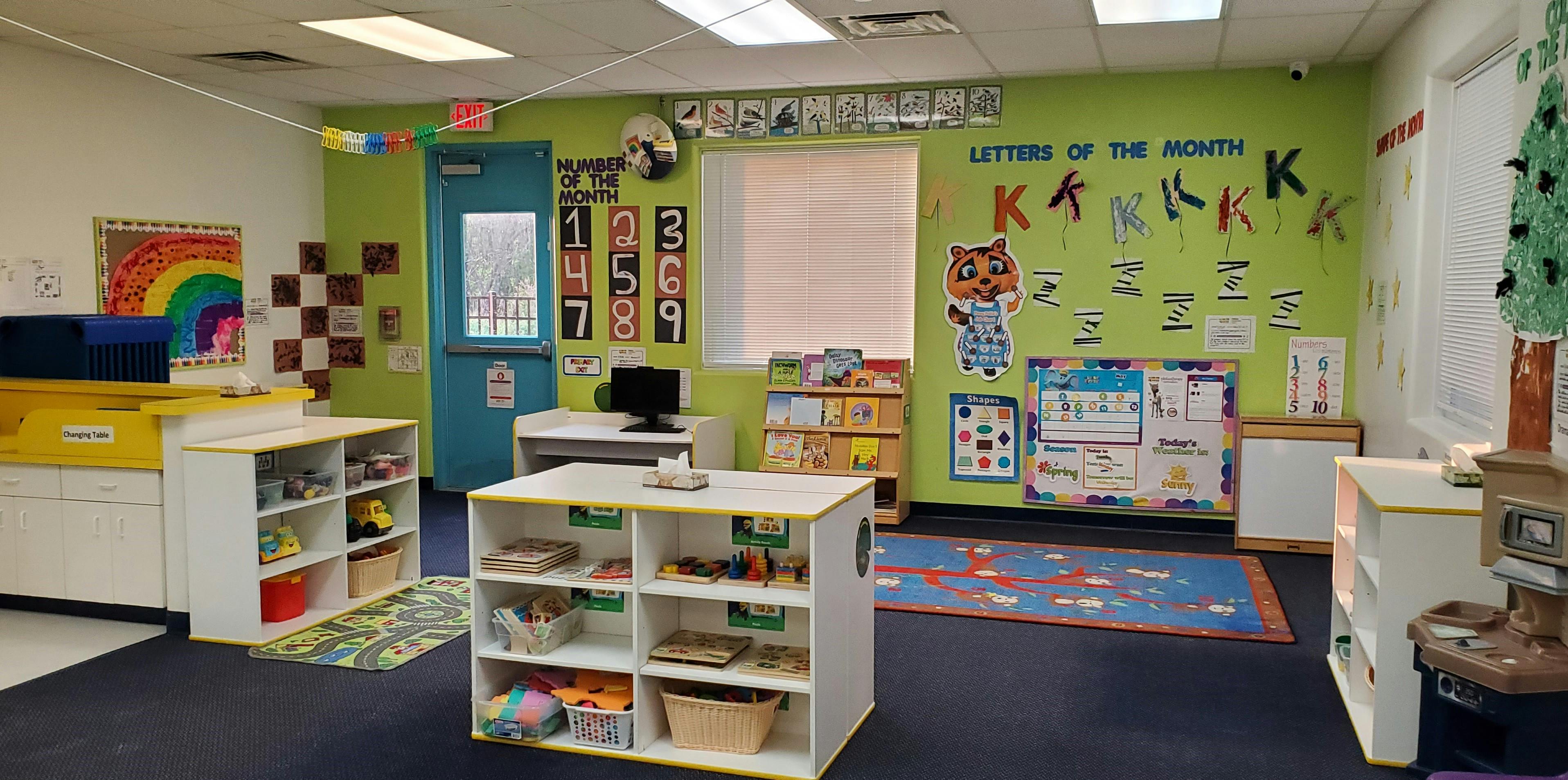 Classroom with green walls and various learning materials