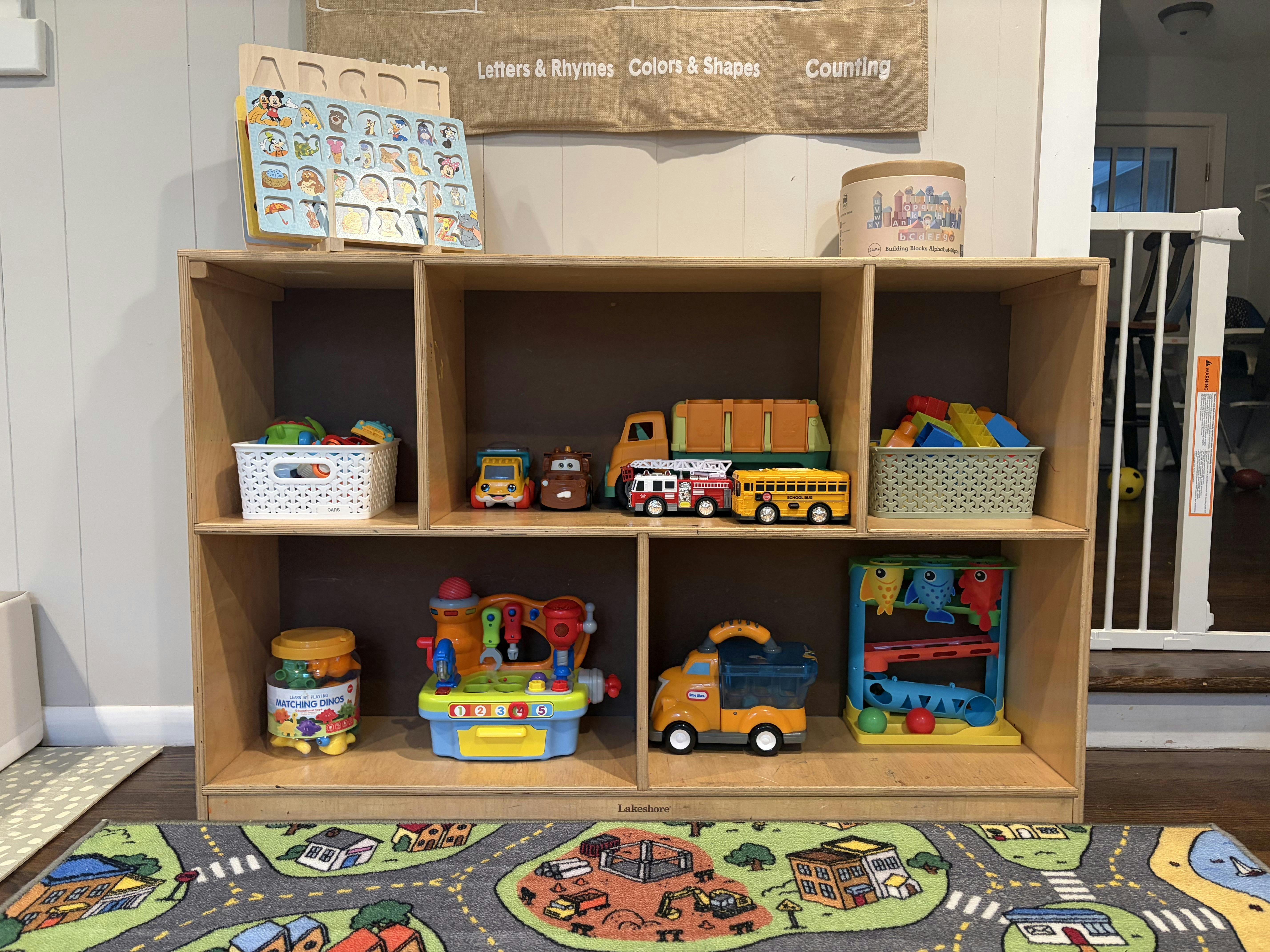 Wooden shelf filled with various children toys