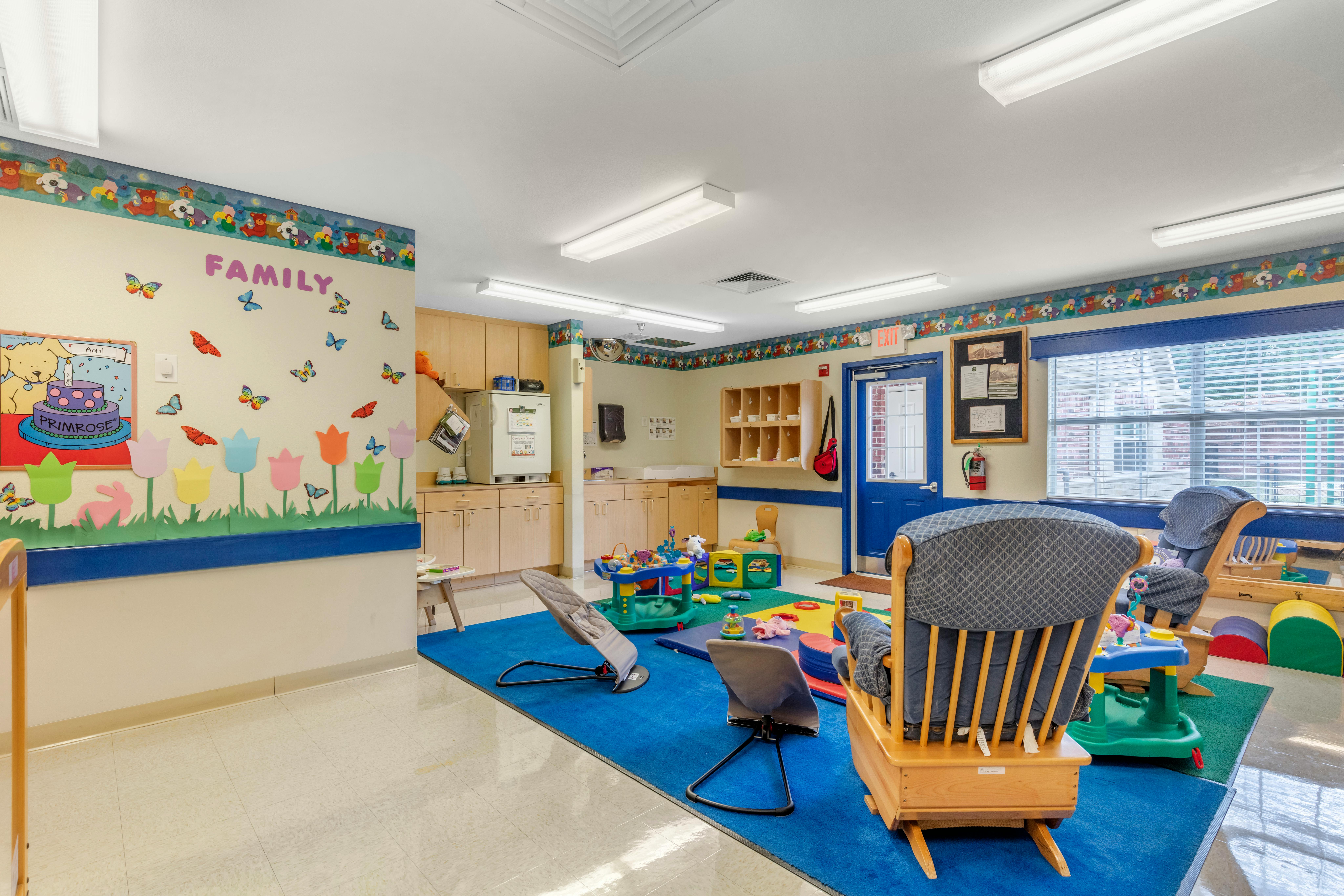 Children's playroom with colorful decorations, toys, and small furniture