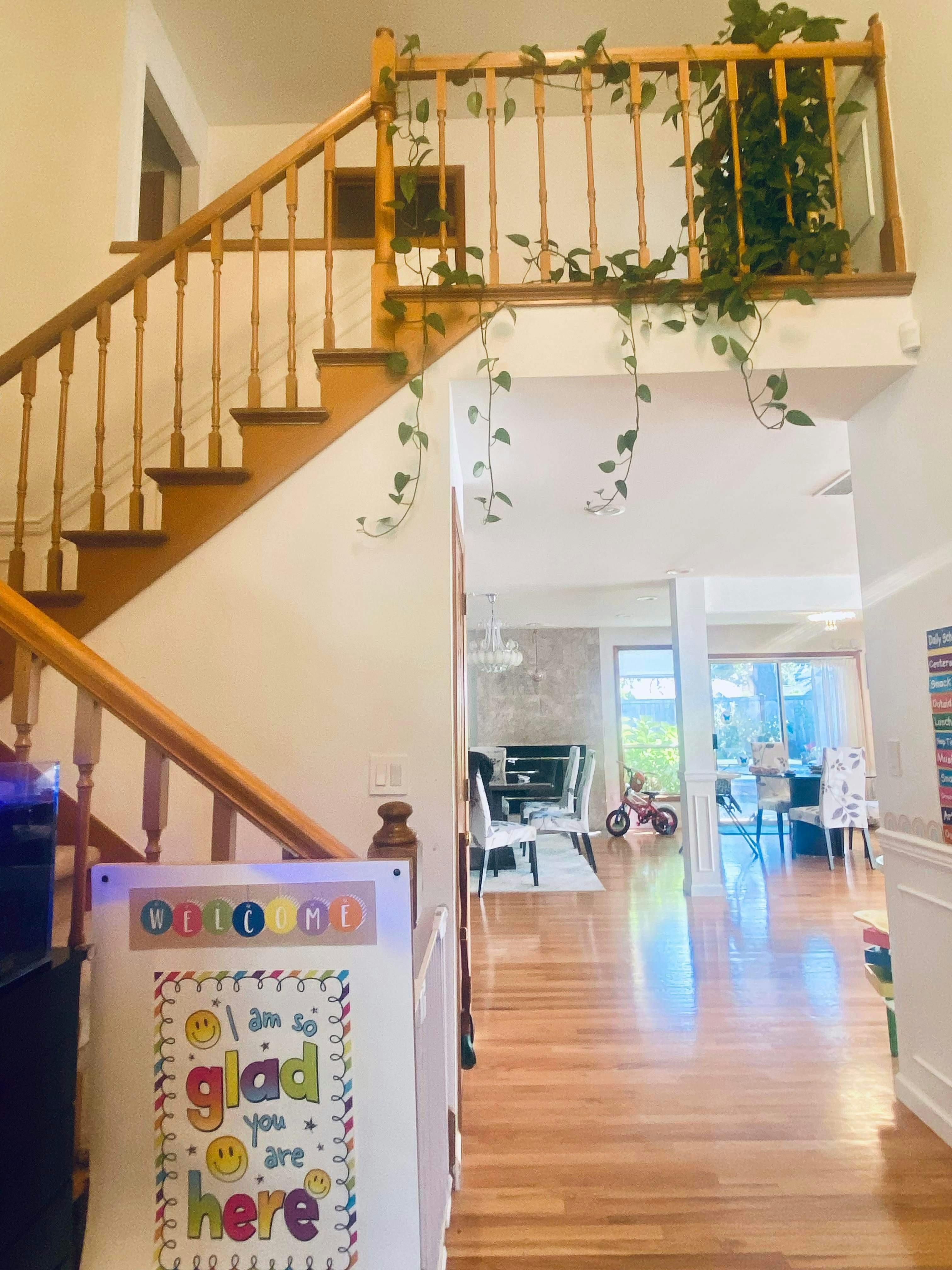 Wooden staircase with a sign that says "I am so glad you are here"