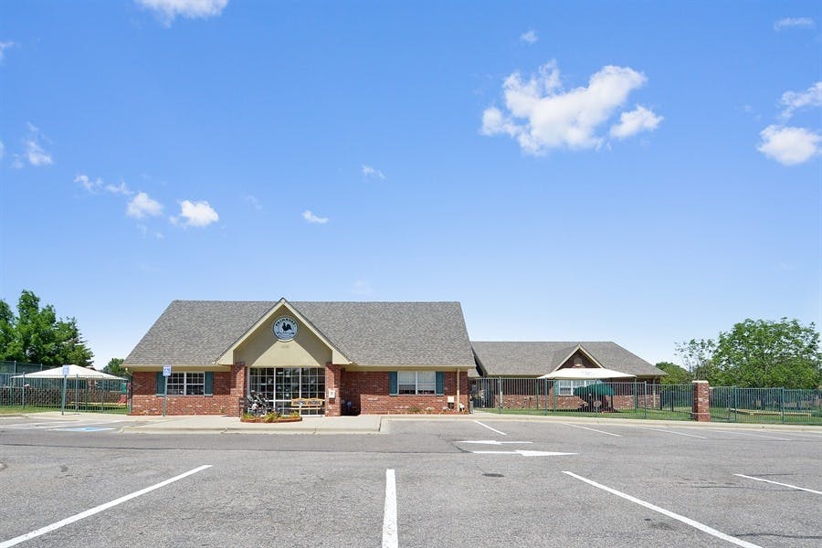 Building with a gabled entrance and a parking lot in front