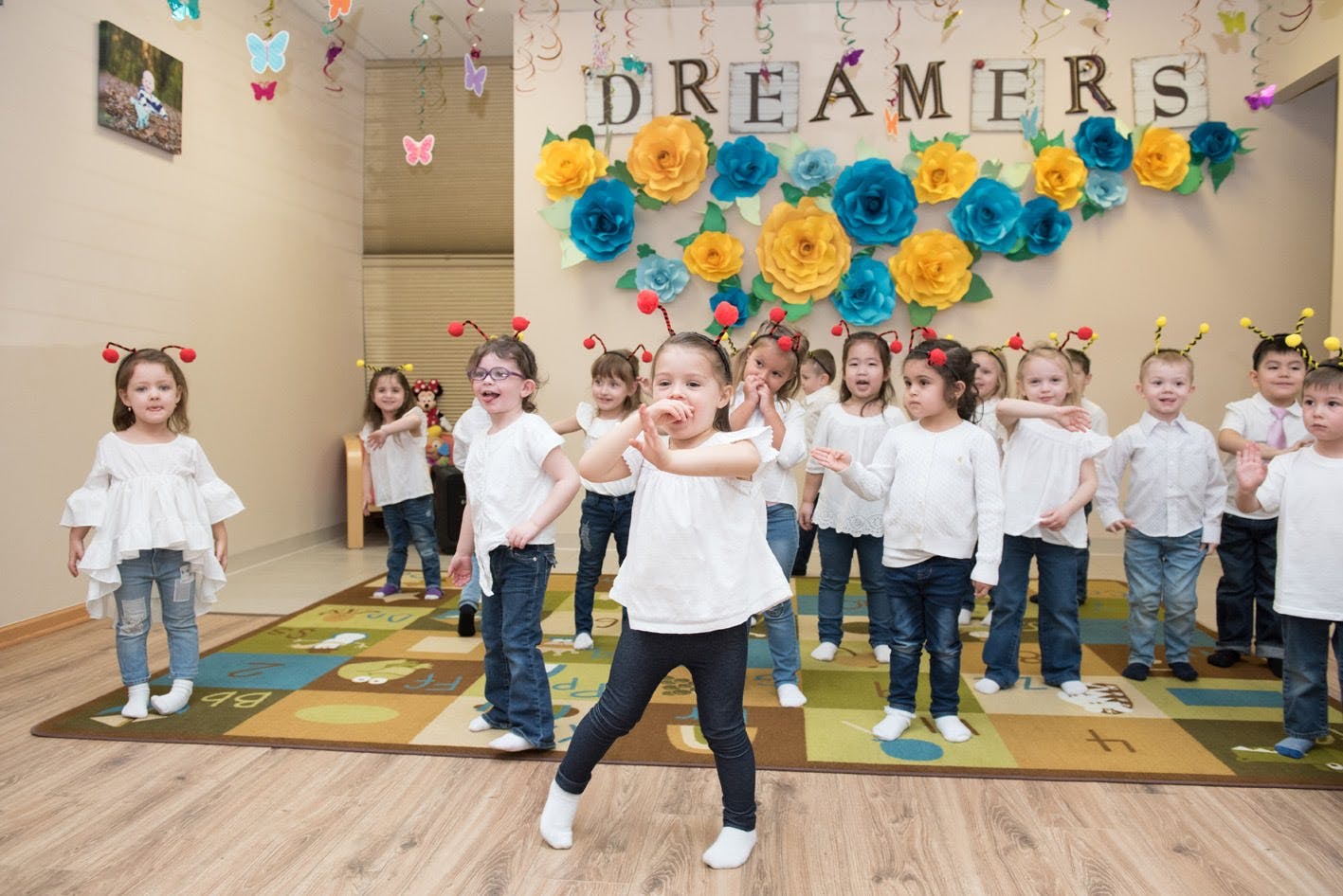 Children in a classroom with "DREAMERS" on the wall