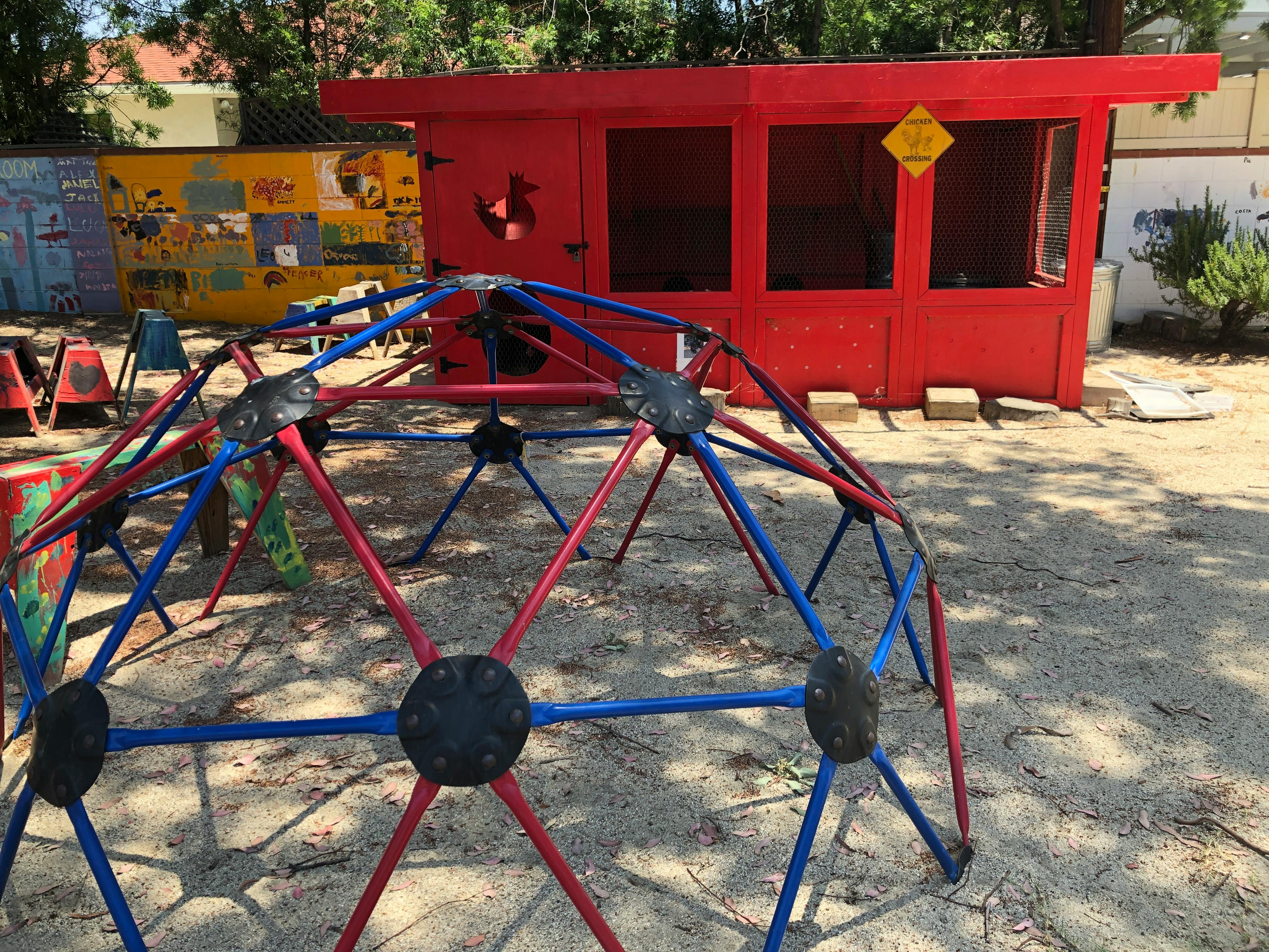 Red and blue geodesic dome climber on a playground
