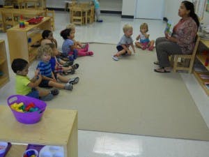 Adult reading to children in a classroom