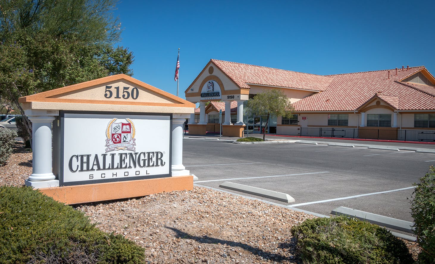Challenger School sign with building in background
