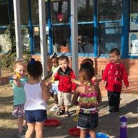Children playing with bubbles outdoors