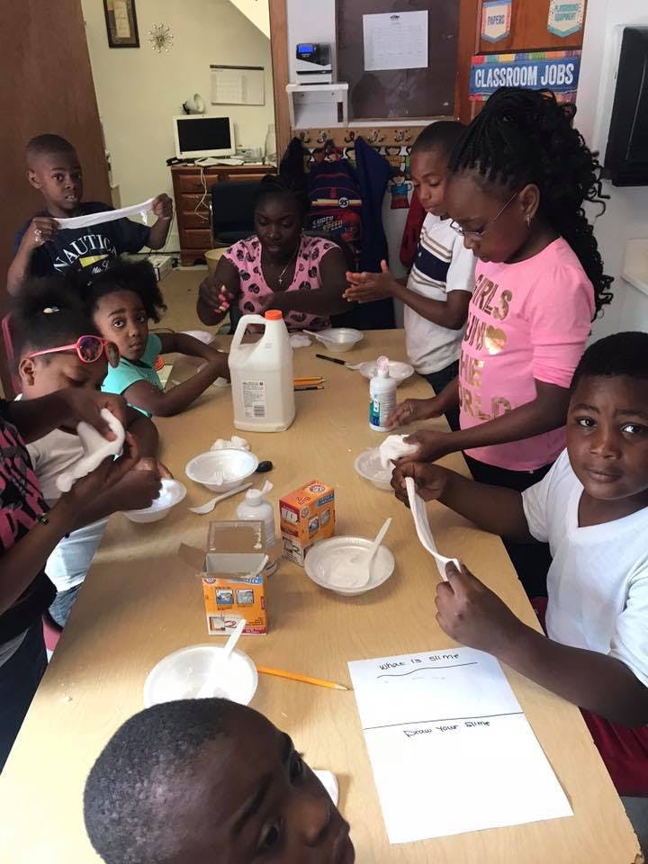 Children at a table making slime