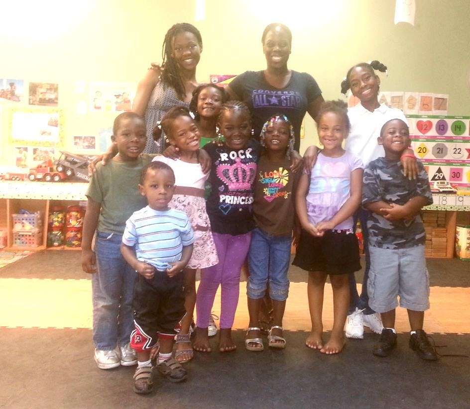 Group of adults and children posing together