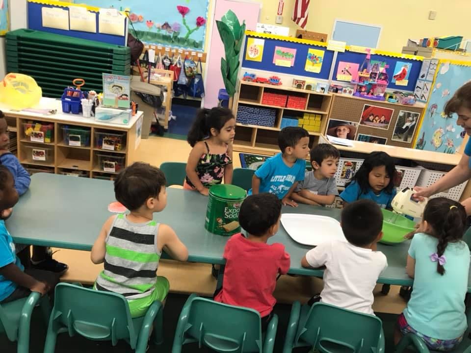 Children sitting at tables in a classroom