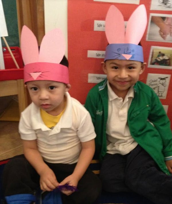 Two children wearing bunny ear headbands