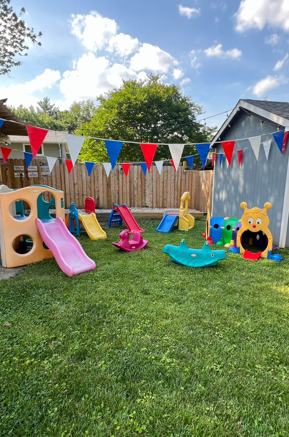 Outdoor playground with multiple slides and play structures on green grass