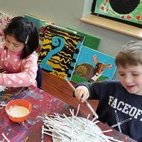 Two children doing crafts at an art activity