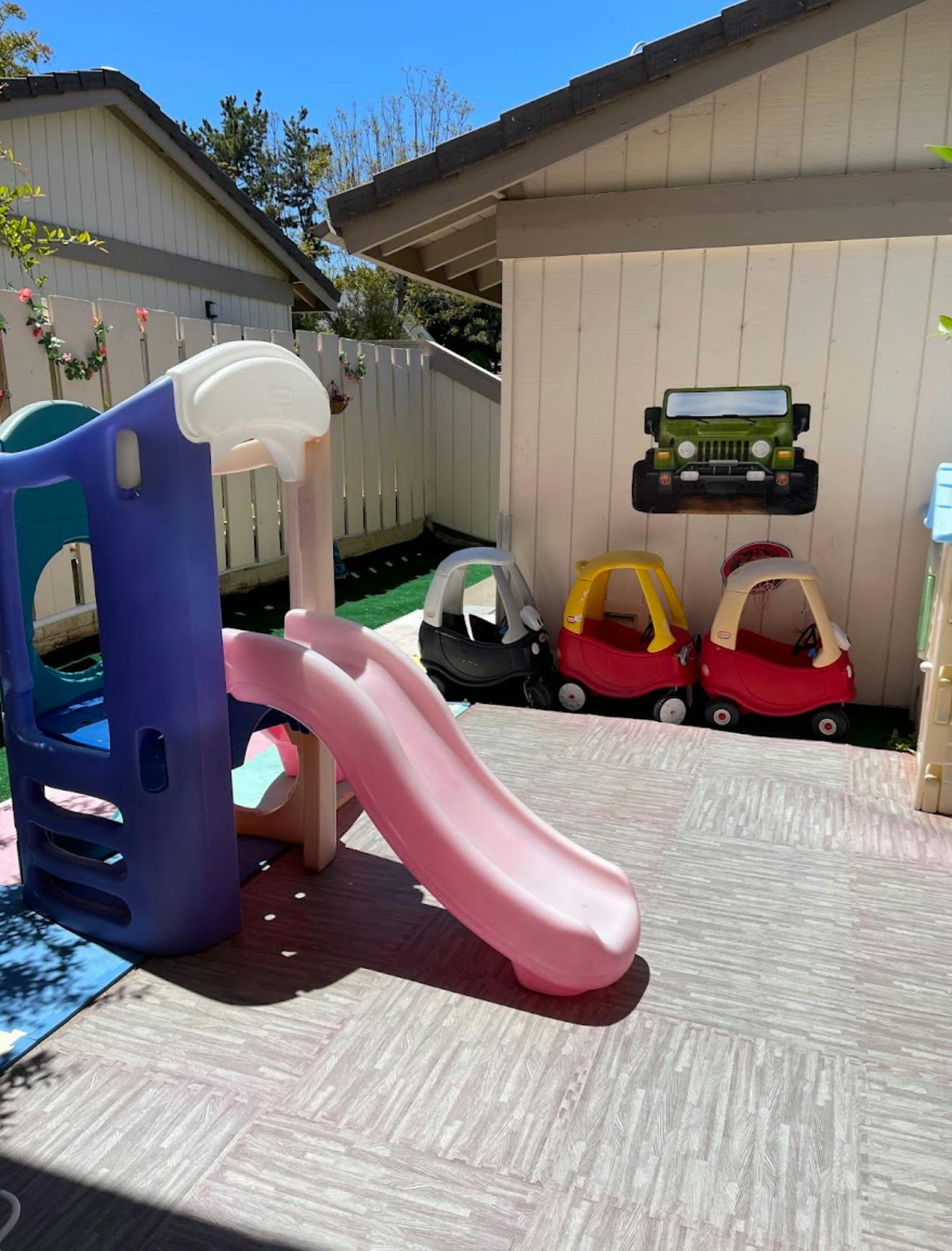 Playground slide and toy cars outdoors