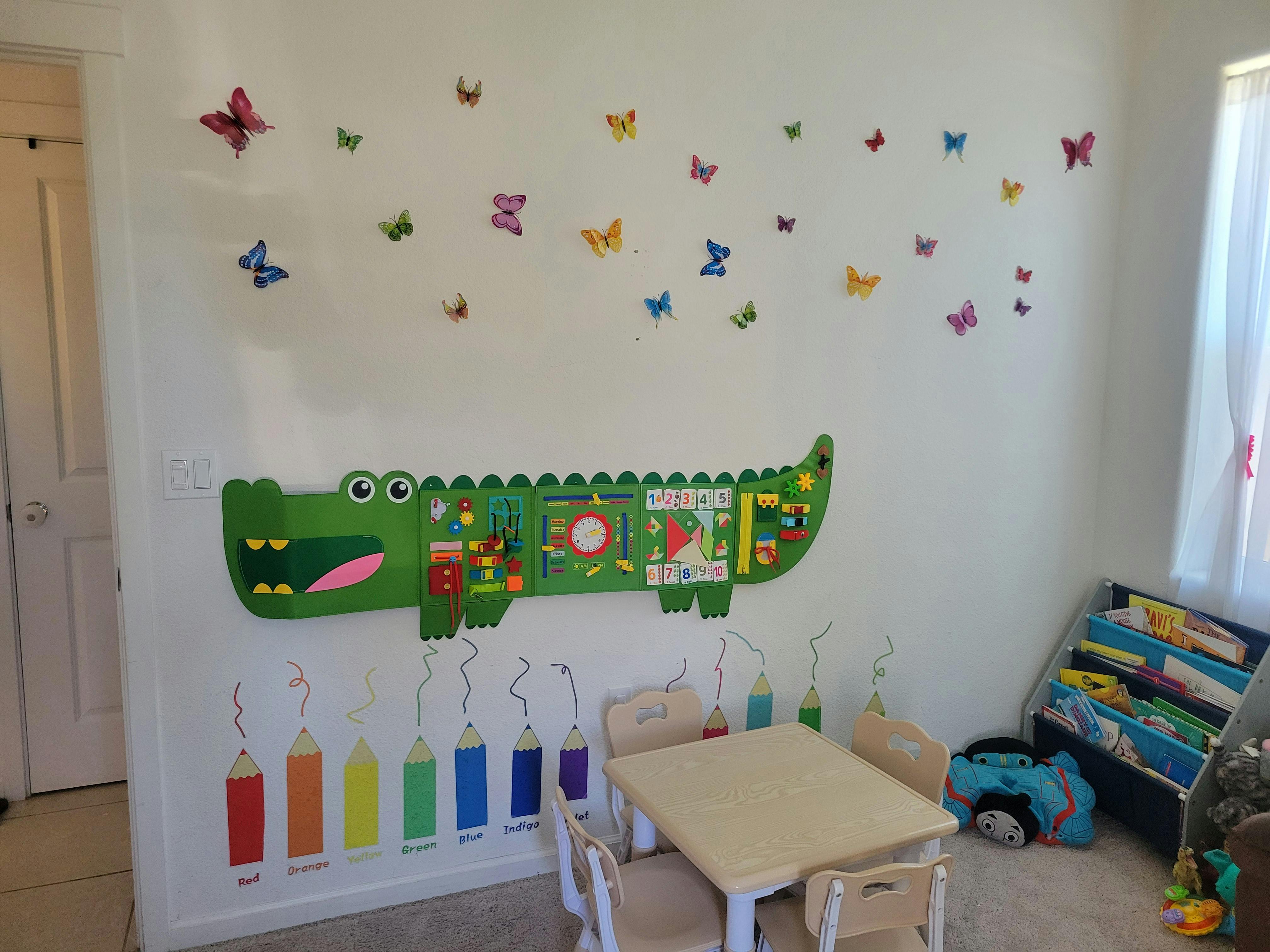 Crocodile sensory wall toy and pencil wall decals in a child playroom