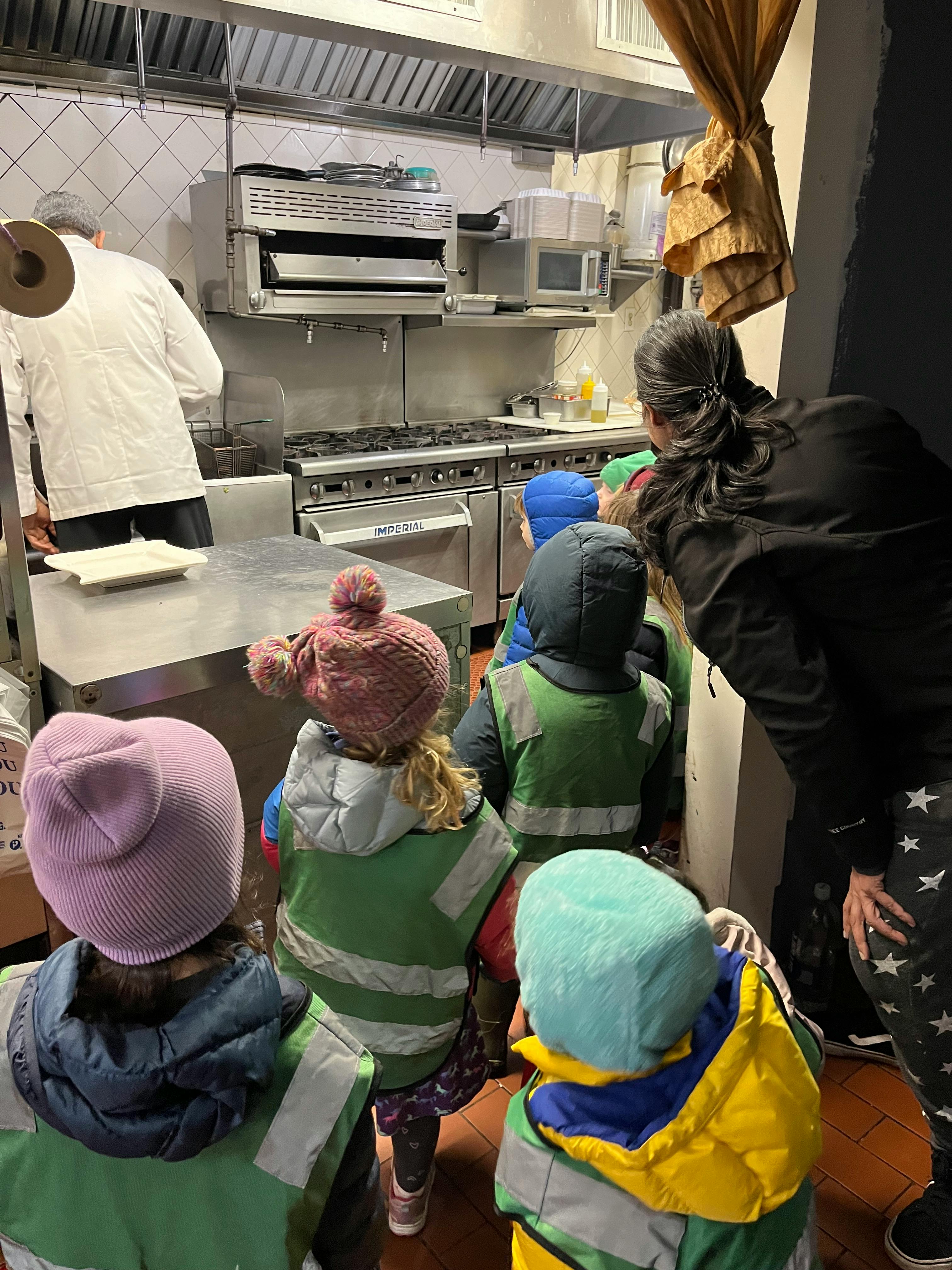 Adults and children in a kitchen