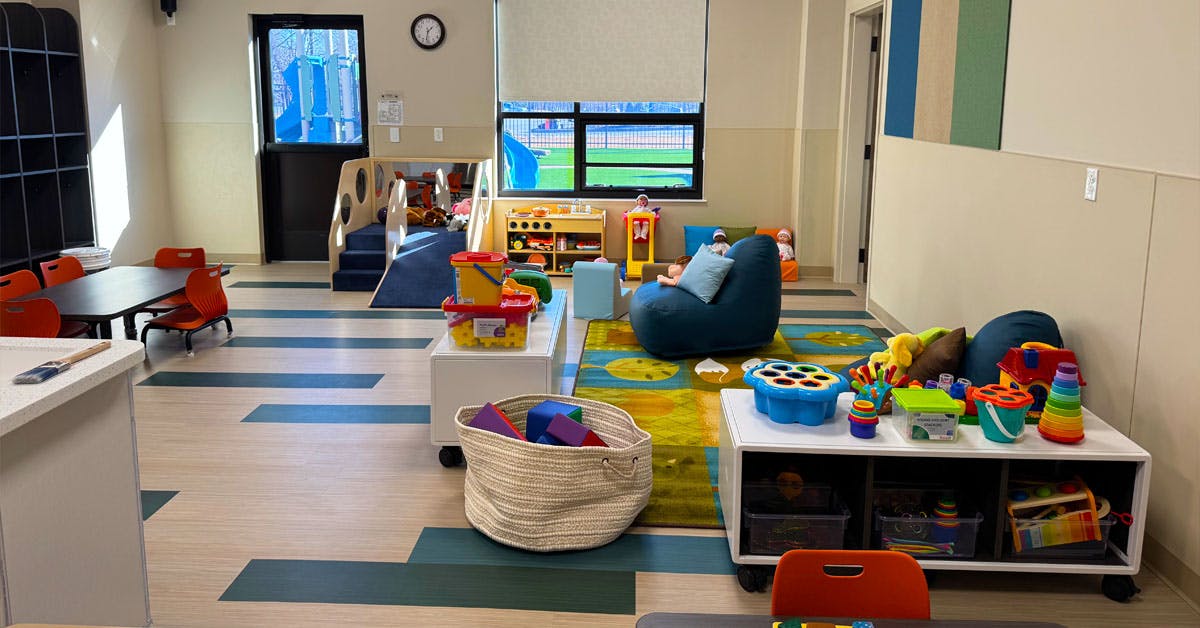 Playroom with various toys, furniture, and a small slide