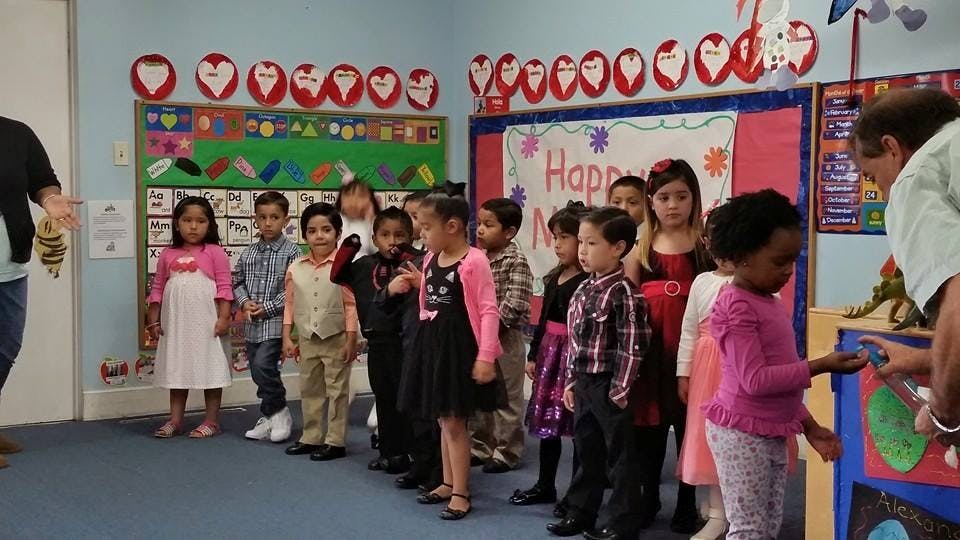 Children standing in a line in a classroom