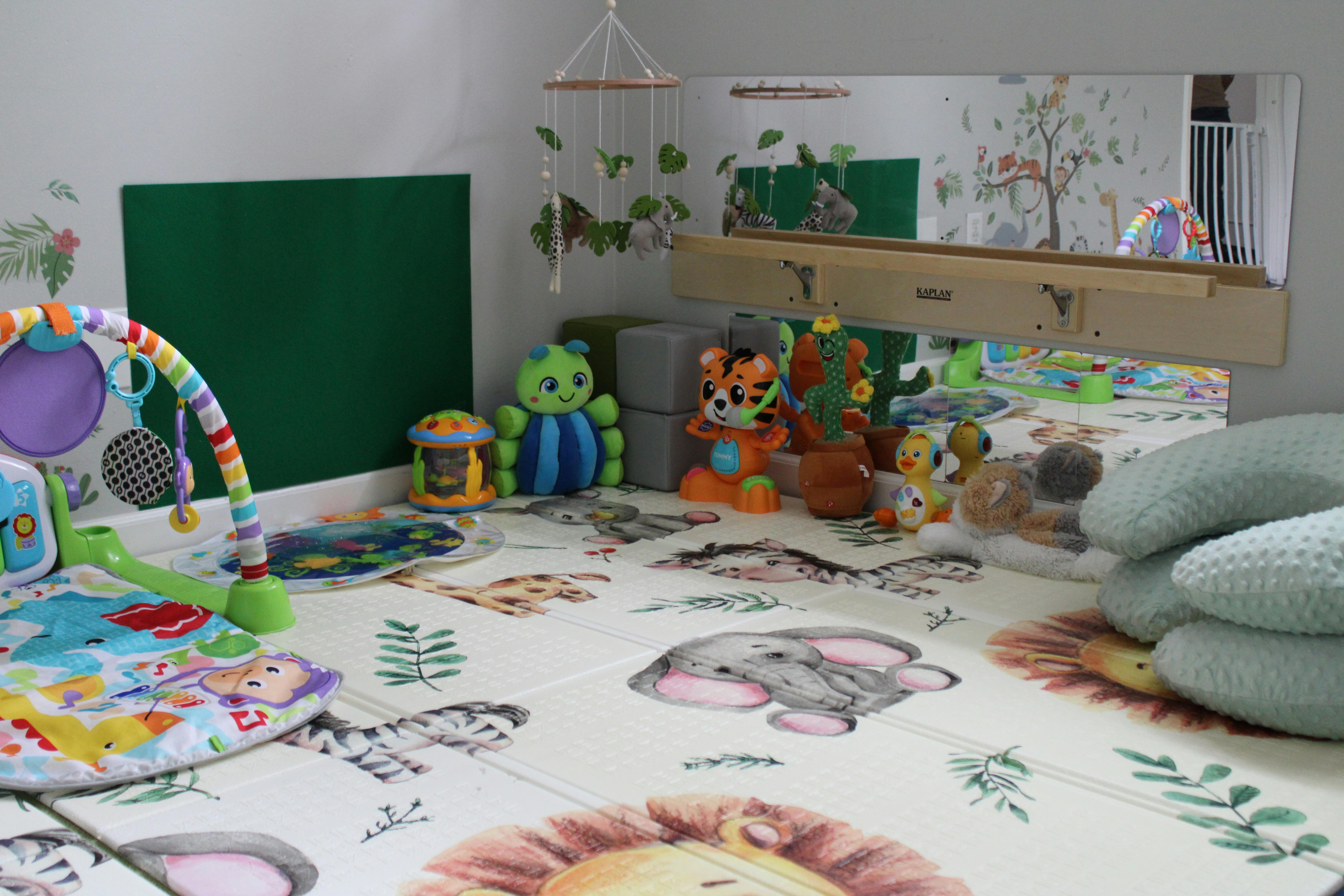 Playroom with a playmat, baby gym, and stuffed animals
