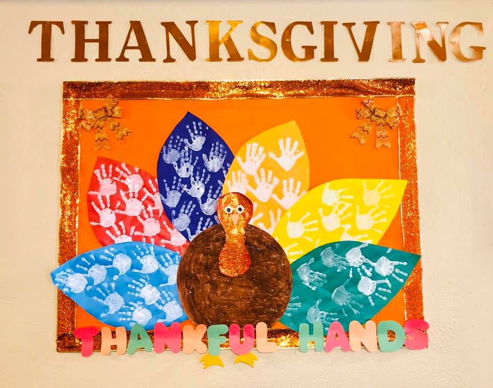 Thanksgiving turkey craft with colorful handprint feathers