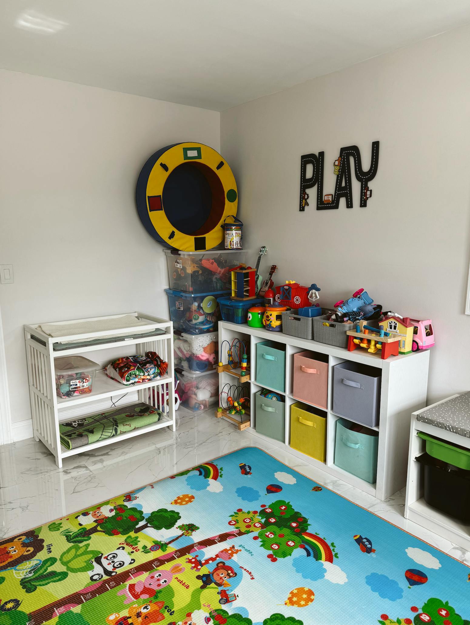 Playroom with toy storage, changing table, and colorful playmat