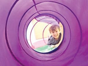 Child in a purple tunnel