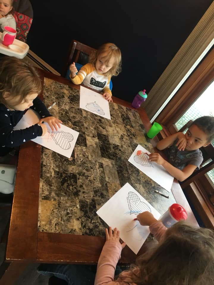 Children coloring at a table