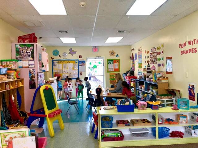 Adults and children in a classroom