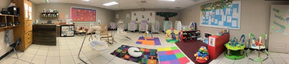Room with play mats, baby swings, and various child toys