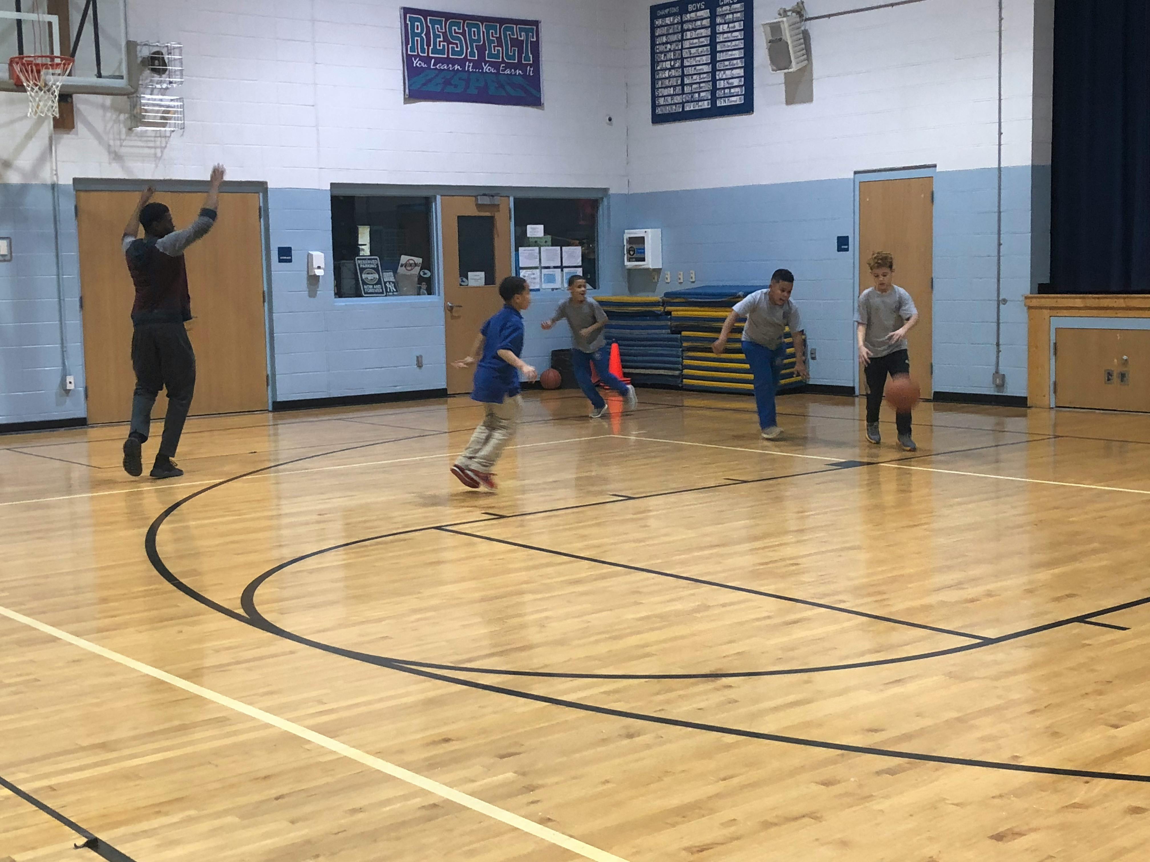 People playing basketball in a gymnasium