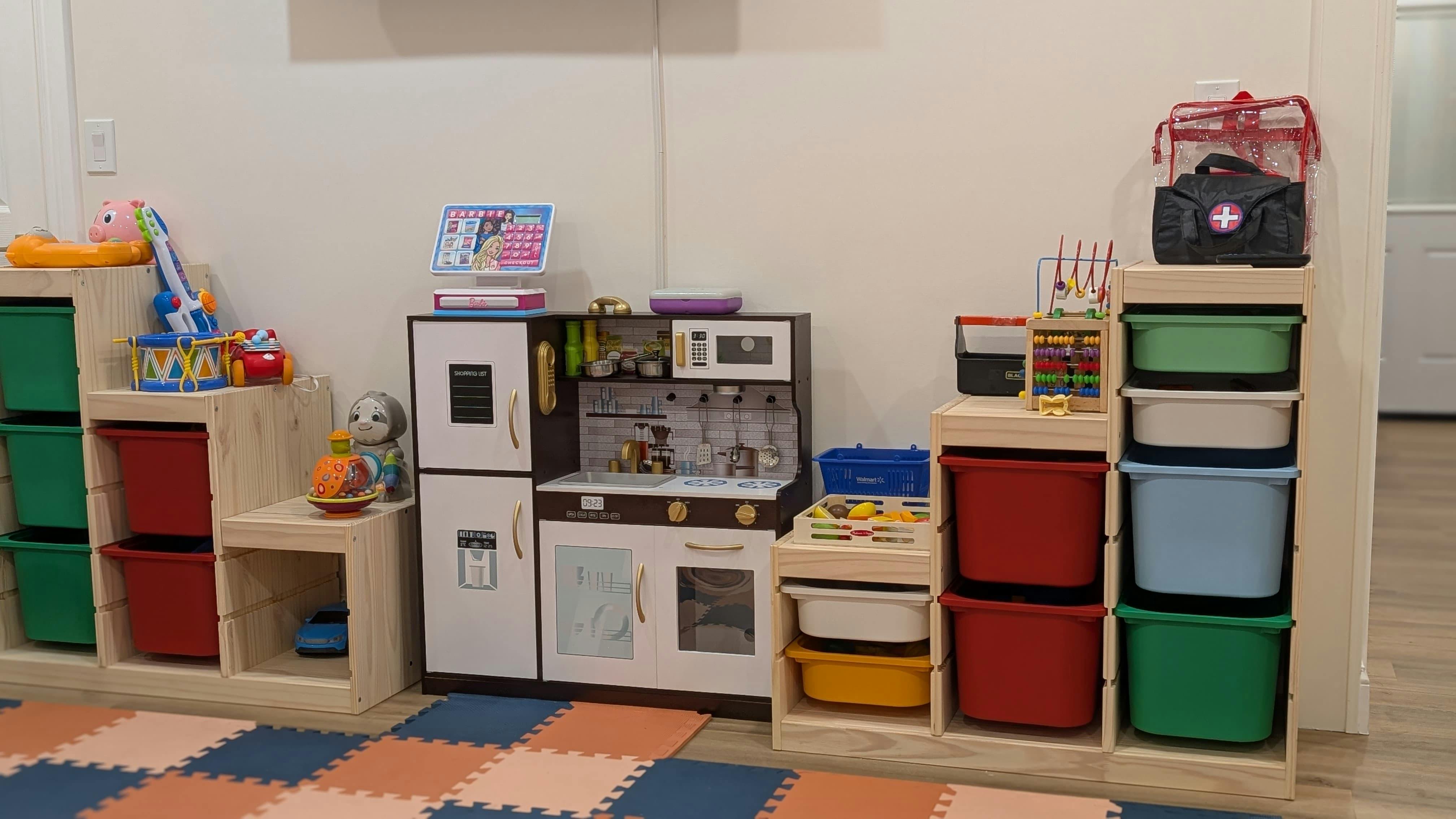 Play kitchen and toy storage bins in a room