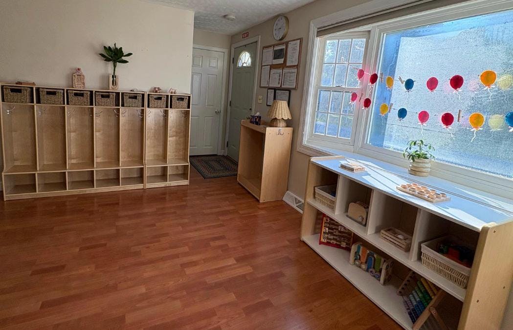 Classroom interior with wooden lockers, shelving units, and balloon decorations